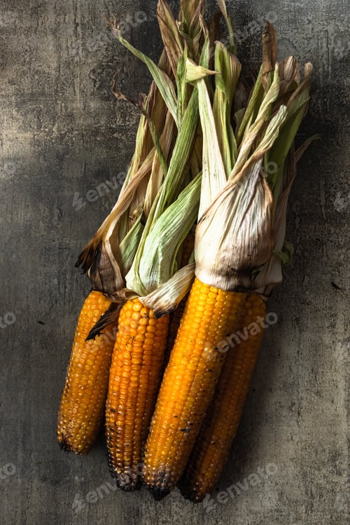 Preview: Roasted corn cobs on stone table, grilled organic food