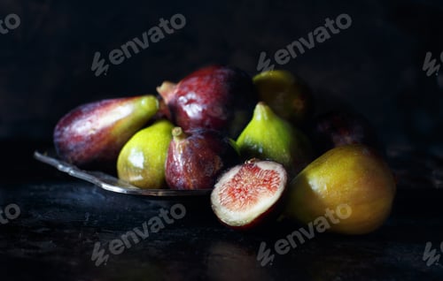 Preview: Green and purple figs on a dark background
