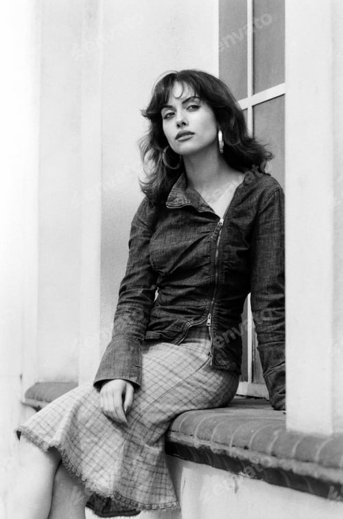Preview: Film portrait of sensual woman sitting on a window outdoors.
