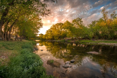 Preview: A river with a beautiful sunset in the background