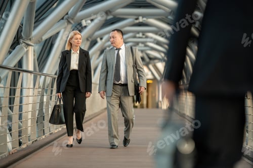 Preview: A man and woman walking down inside contemporary business center