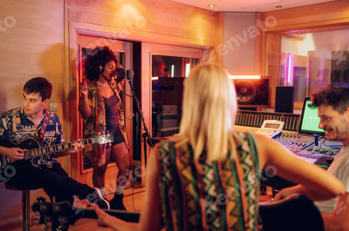 Preview: Professional diverse musicians recording a song at music studio.