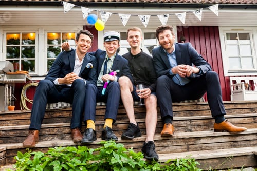 Preview: Portrait of four men sitting on wooden steps