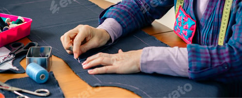 Preview: Senior female seamstress sewing cloth