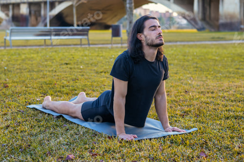 Preview: Man practicing yoga cobra pose for wellness and relaxation
