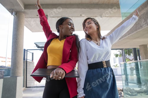 Preview: Two female colleagues celebrate the achievement of a goal at work, success and happiness at work.