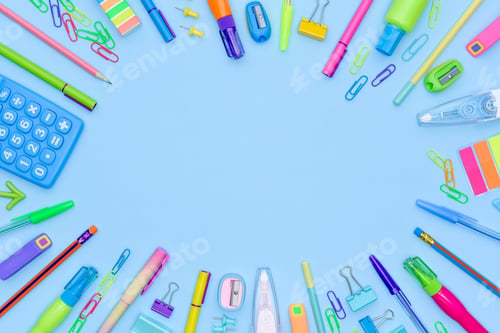 Preview: Frame of different stationery items on blue background with copy space.
