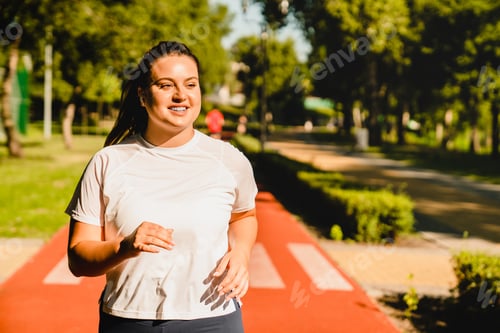Preview: Fat athlete running jogging losing weight burning calories while listening to music in stadium