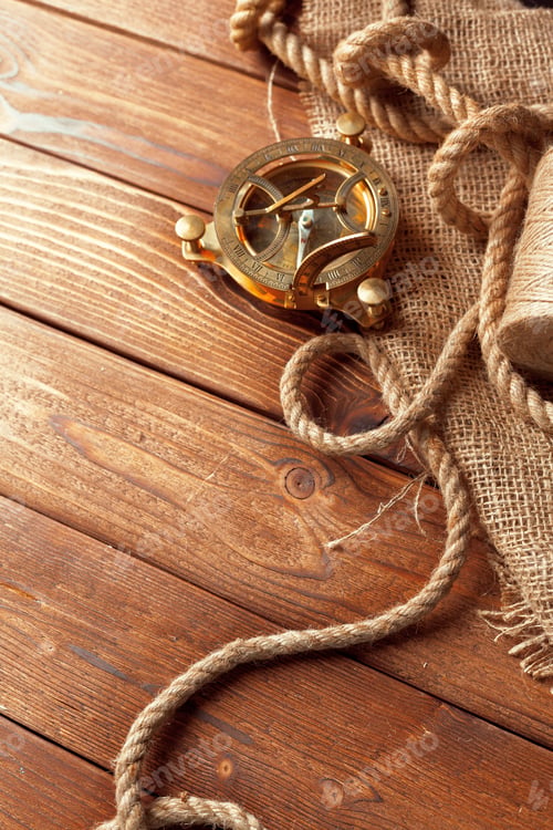 Preview: compass and rope on old wooden boards