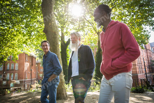 Preview: Three mature men walking in street