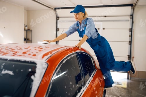 Preview: Female washer wipes the automobile windshield