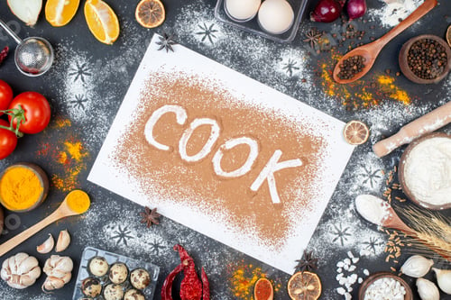 Preview: top view cook writing with eggs vegetables raw pasta and seasonings on dark background dough