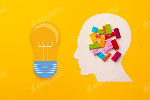 Preview: Papercut head silhouette with toy constructor pieces on yellow background
