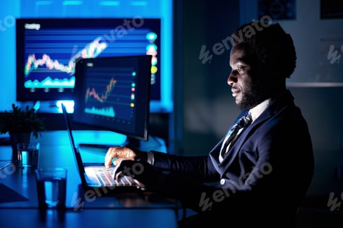 Preview: African American employee typing on laptop in workspace