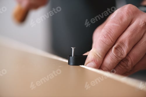 Preview: a man collects furniture, drives in a nail.
