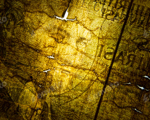 Preview: Closeup macro shot of a paper currency bill, with various elements of the design