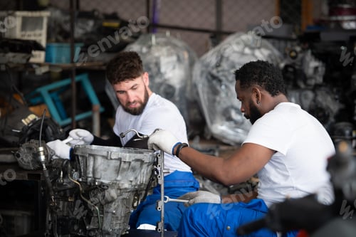 Preview: Two men repairing car engine in auto repair shop, Selective focus.