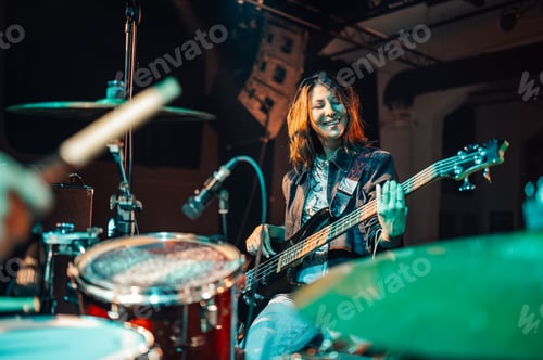 Preview: Smiling Woman Plays Bass Guitar on Stage