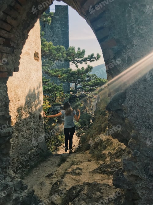 Preview: Woman Exploring Old Stone Ruins on Hilltop Trail