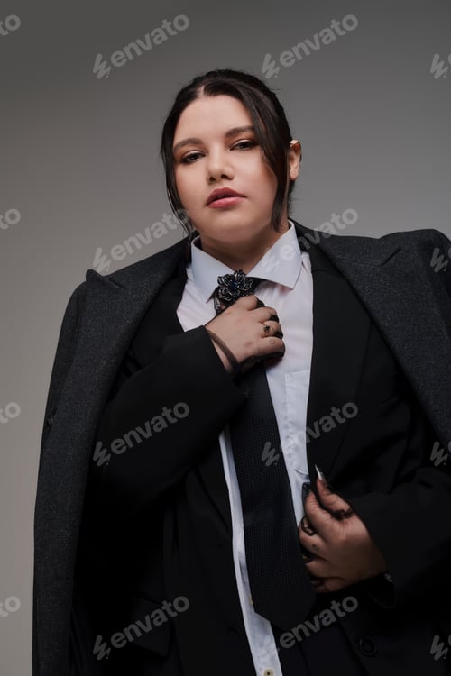 Preview: Stylish plus size woman radiates confidence in a chic black suit and elegant accessories