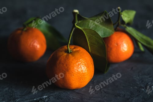 Preview: Juicy ripe tangerines with leaves on wooden table