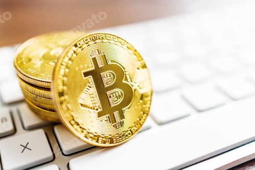 Preview: Cryptocurrency. Bitcoin virtual money. Gold coins laying on computer keyboard.