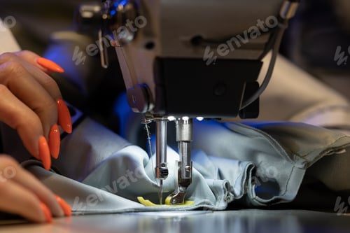 Preview: Seamstress work on sewing machine, closeup. Woman fashion designer create new clothes collection