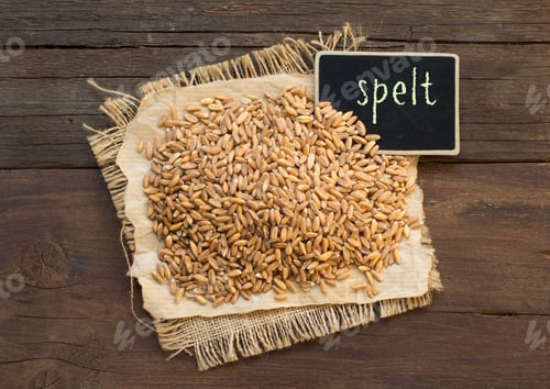 Preview: Whole unpolished spelt in a with a small chalkboard