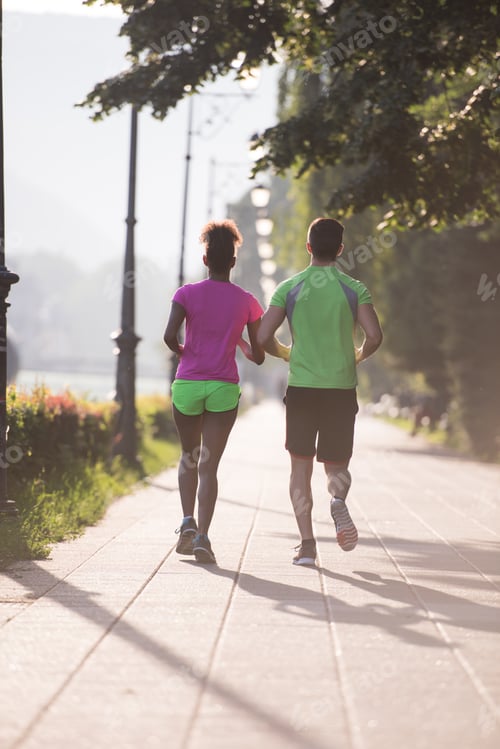 Preview: young multiethnic couple jogging in the city