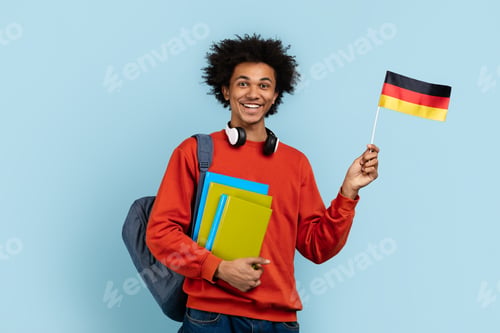 Preview: Friendly student holding German flag and books