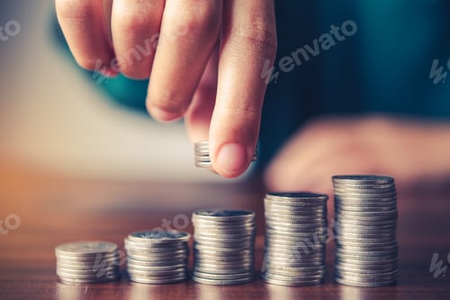 Preview: Stacks of Coins Showing Growth on Wooden Surface