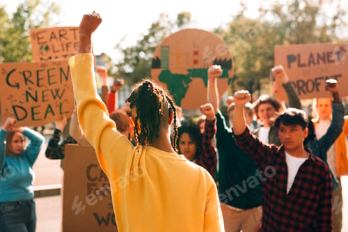 Preview: Climate change protest with activists raising fists and holding signs