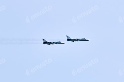Preview: Two Russian military fighter planes armed with missiles flies in blue sky, airborne mission