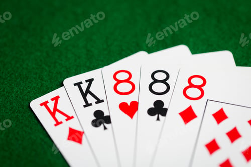 Preview: poker hand of playing cards on green casino cloth