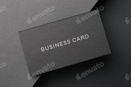 Preview: Business card on black background, top view