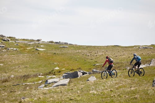 Preview: Cyclists cycling on rocky hillside