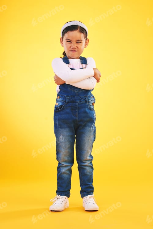 Preview: Arms crossed, angry and portrait of girl child in studio with bad, attitude or behavior problem on