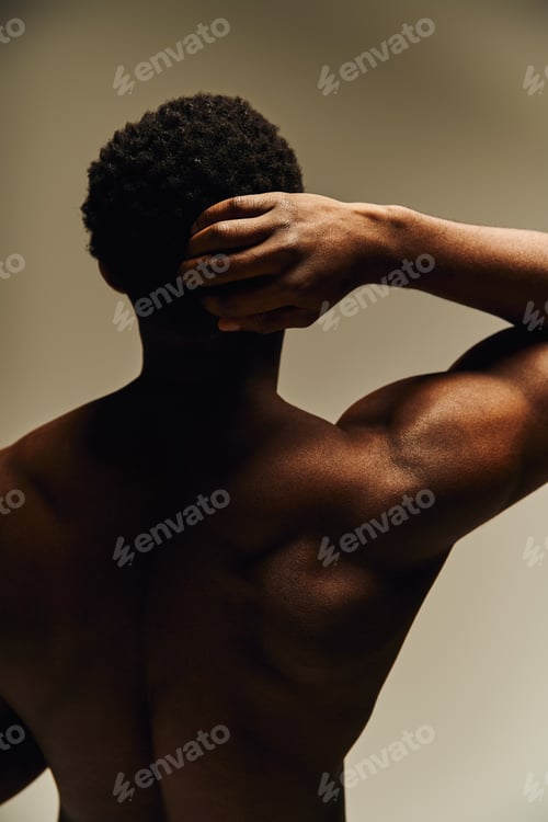 Preview: Young handsome african american man showcasing confidence and strength in a creative art setting