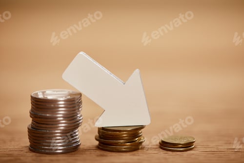 Preview: decreasing chart made of coins with white arrow, bankruptcy concept
