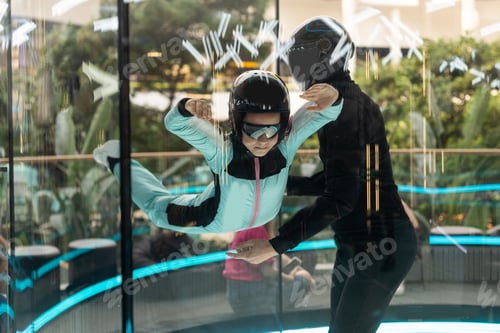 Preview: A teenage girl and an instructor climb up in an air tube