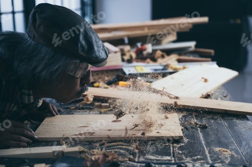 Preview: A carpenter is making crafts from wood.