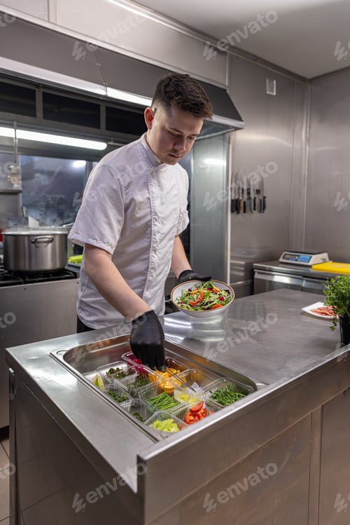 Preview: Chef using tongs and holding plate