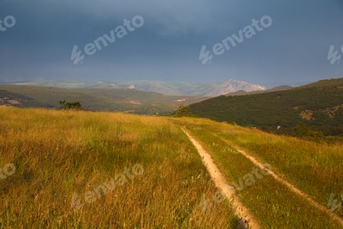 Preview: red sunset over green field with road