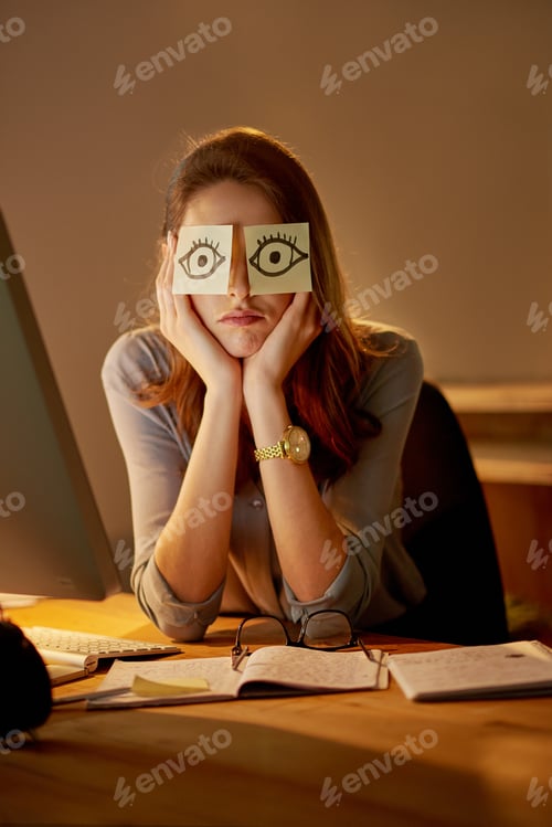 Preview: Portrait of an attractive young businesswoman sitting with sticky notes over her eyes in the office