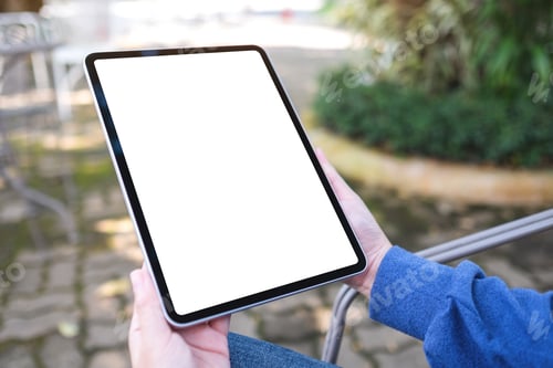 Preview: Mockup image of a woman holding digital tablet with blank white desktop screen in the outdoors
