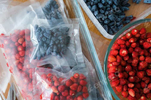 Preview: Vacuum sealer of strawberries, honeysuckle in bag, packaging for long-term storage . Vacuum packing