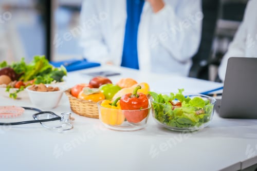 Preview: Two nutritionists,female and male, work in a hospital, analyzing vegetable and fruit salads