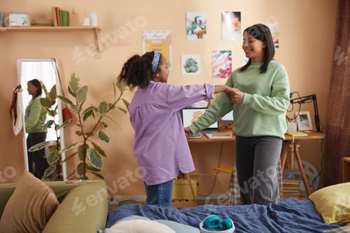 Preview: Black girl dancing with mother and having fun in room