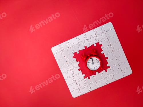 Preview: Concept red alarm clock and puzzle on red background