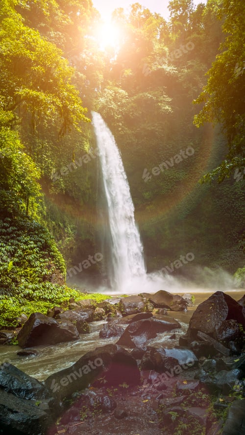 Preview: Amazing Nungnung waterfall with sunlight flares, Bali, Indonesia